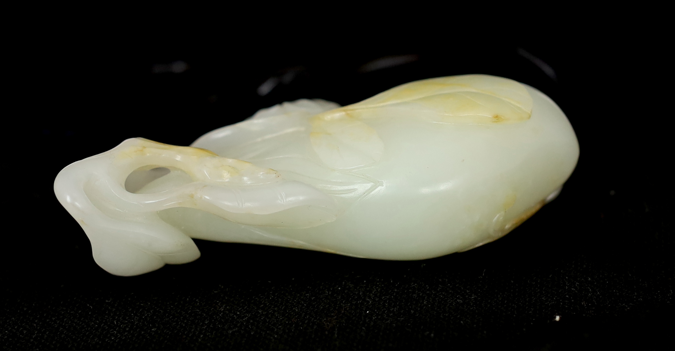 A Chinese pale celadon jade carving of a fruit, 18th century